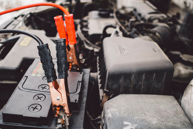 Jumper cables on a car battery